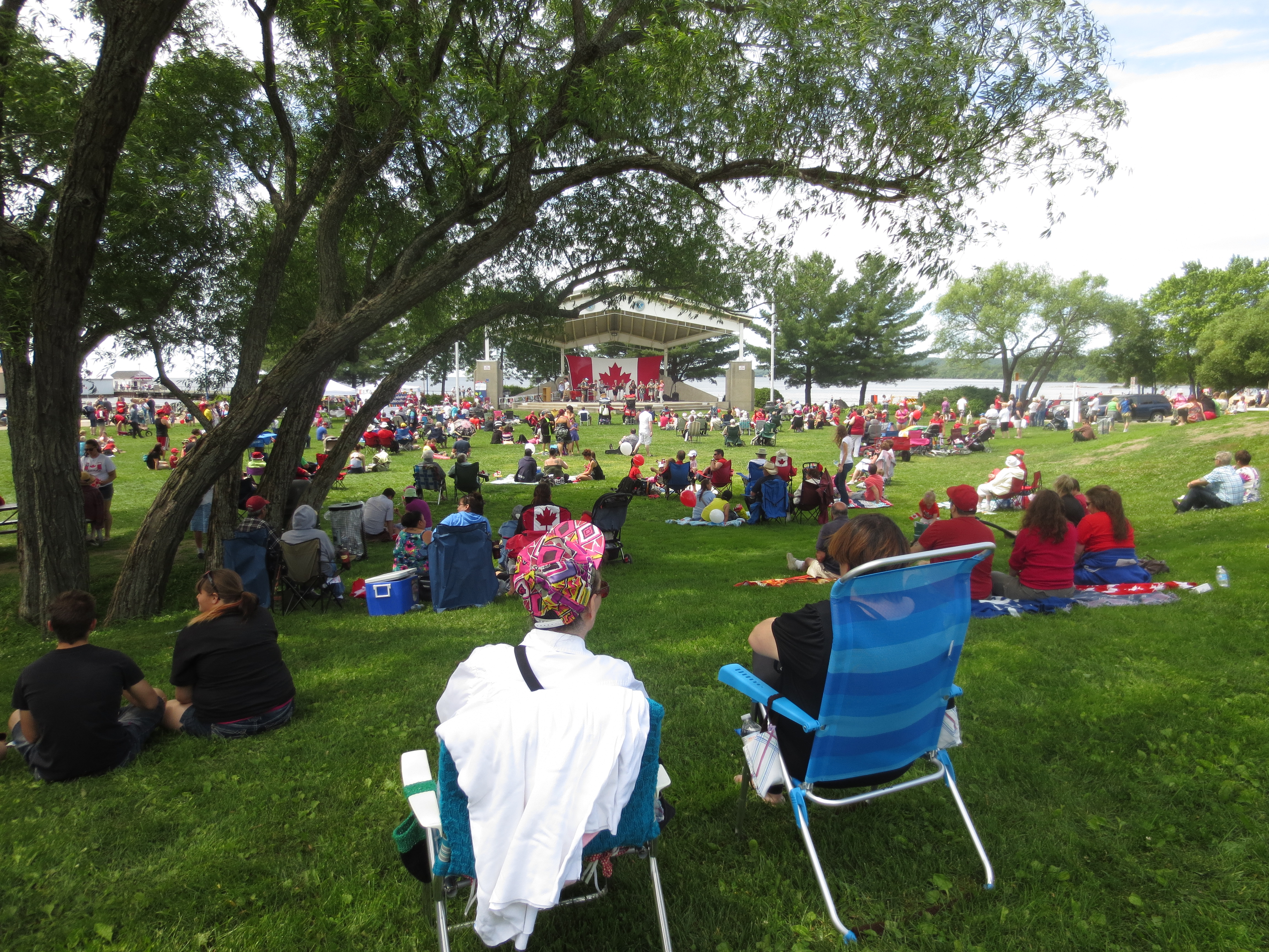 Residents sitting on the grass at a Canada Day  event